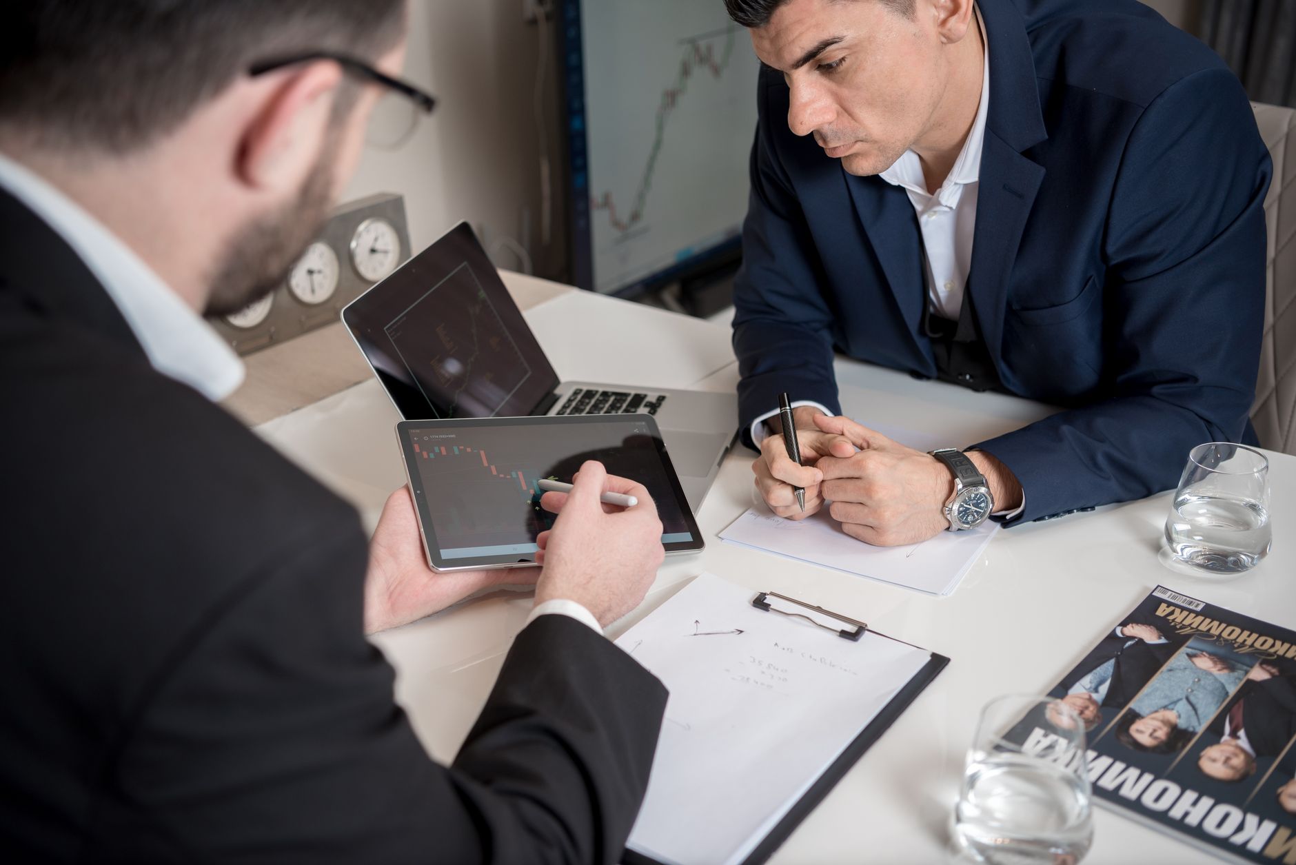 Reviewing a chart on a tablet during a meeting